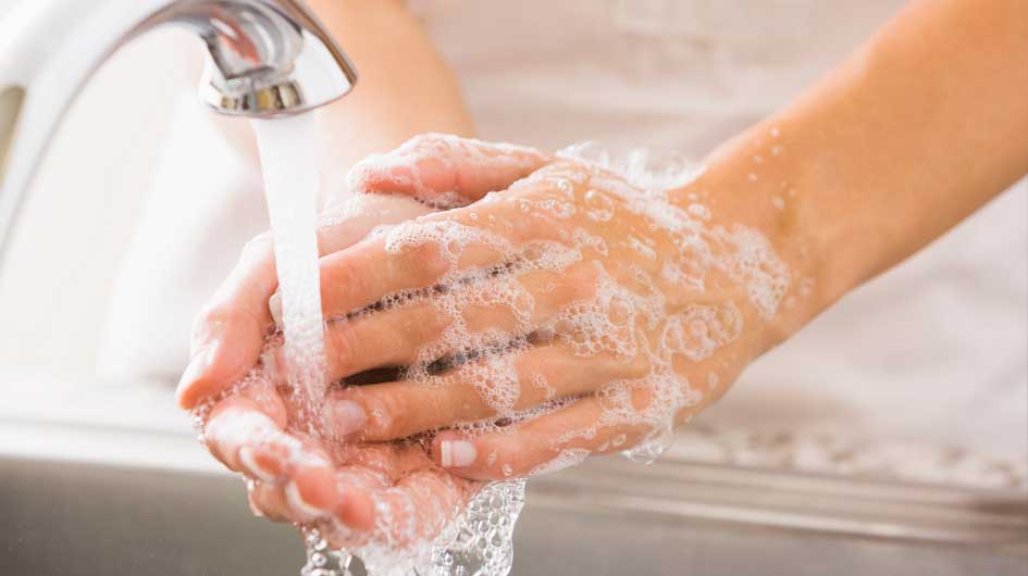 Image of person washing hands with soap and water
