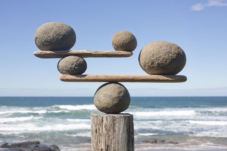 Zen rocks balanced on top of each other on a beach