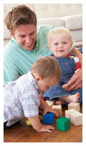 Dad with two sons playing with blocks. page 12