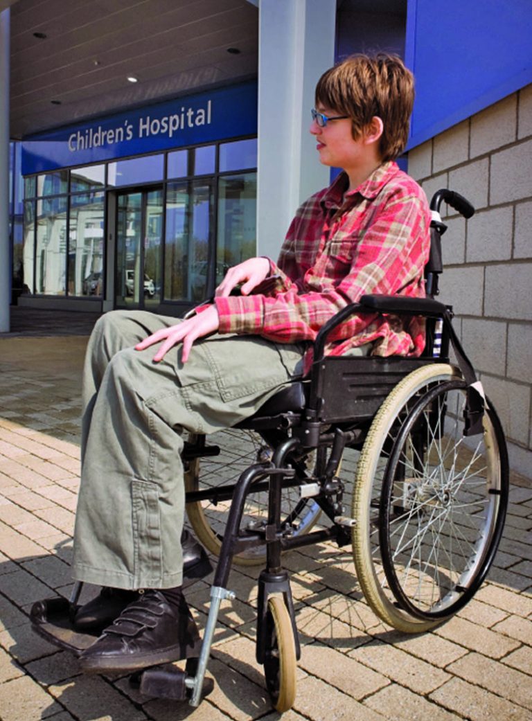 Person sitting outside in a wheelchair.