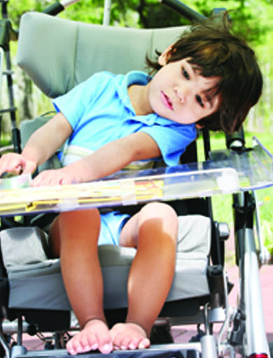 Young boy sitting in wheelchair. Page 34