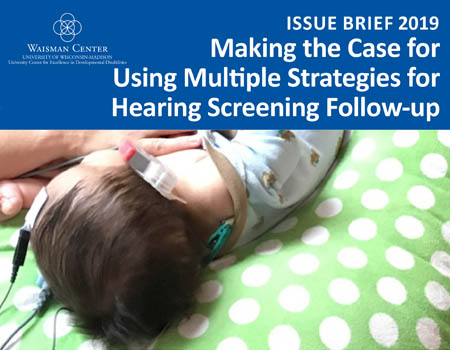 Baby laying on blanket having a hearing screening follow up
